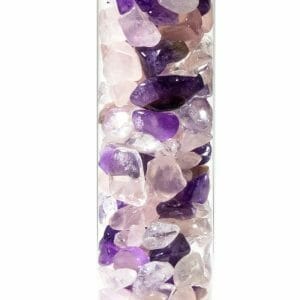 A close-up view of a vertical glass tube filled with polished amethyst and quartz stones in various shades of purple and pink, illustrating the beauty of скъпоценни камъни using the Пръчица за пречистване на вода със скъпоценни камъни "Витален микс".