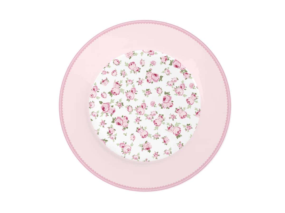 Порцеланова десертна чиния Малки цветя 19 см върху розова чиния.
